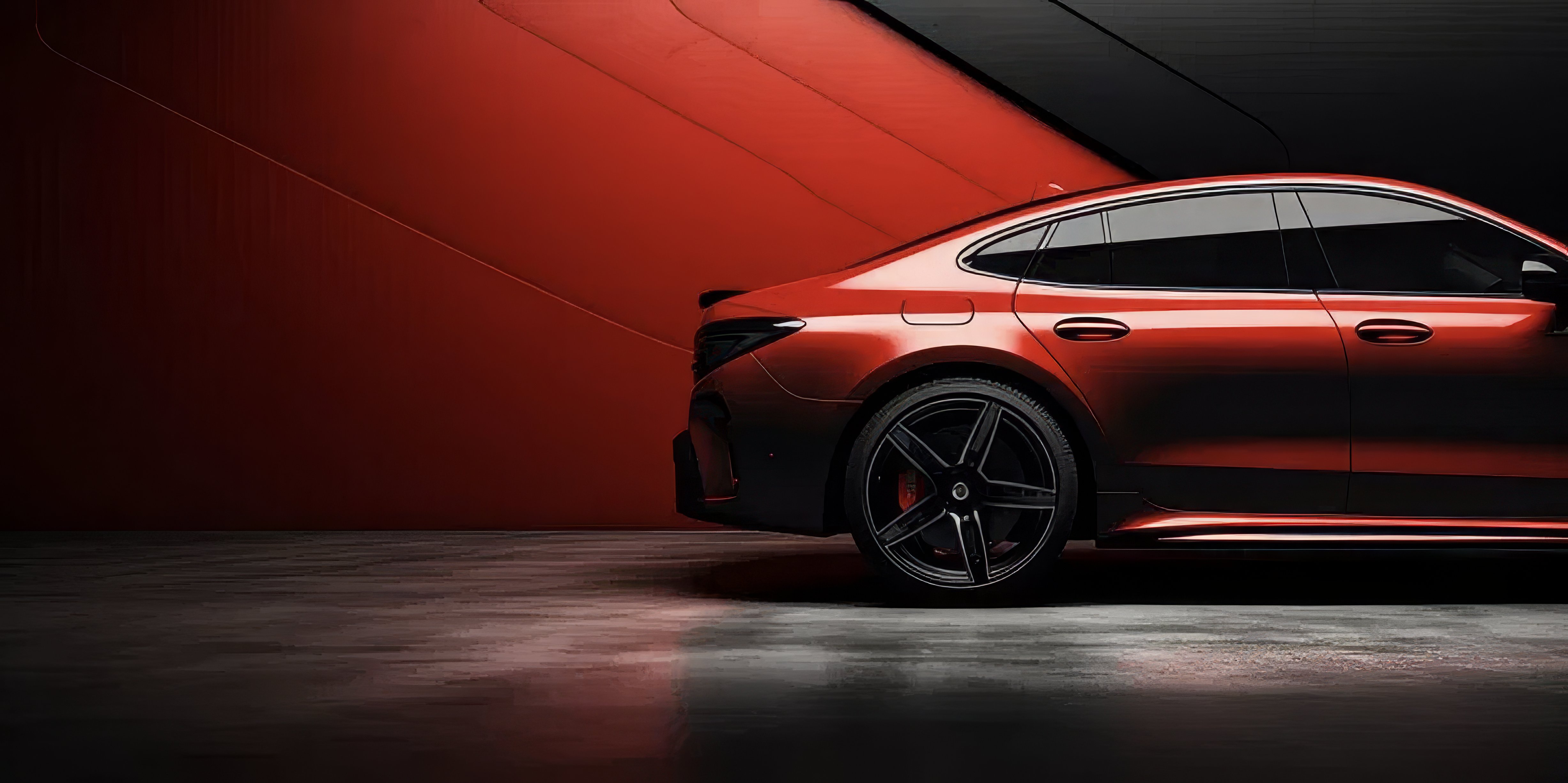 Red luxury sedan side profile — wheel alignment service